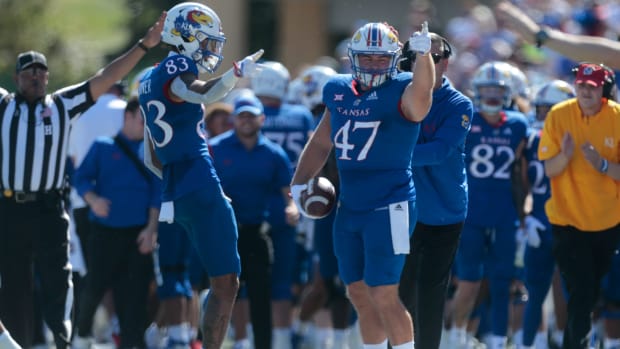 Kansas redshirt sophomore tight end Jared Casey (47) motions downfield getting a first down in the first quarter of Saturday's game inside David Booth Kansas Memorial Stadium.